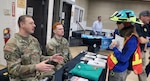 Sgt. Rocco Carley, an Oregon Army National Guard recruiter with 2-162 Infantry Battalion, and Pfc. Christian Patino, also an infantryman 2-162, speak with a community member during the Wildfire Readiness Fair in Corvallis, Oregon, on May 2, 2026. Photo by Sgt. 1st Class Cory Grogan.