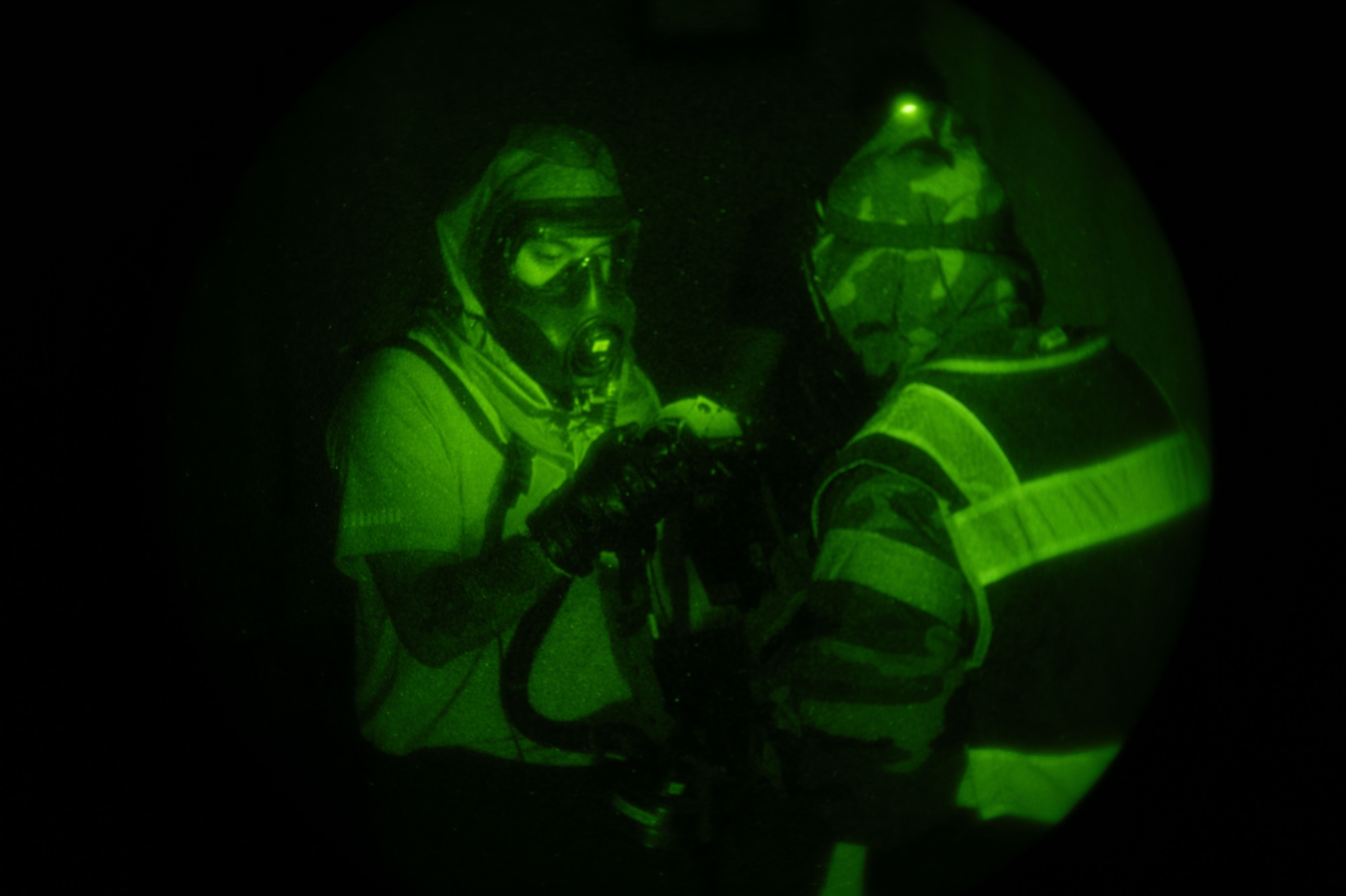 A team of people exam equipment in the dark.