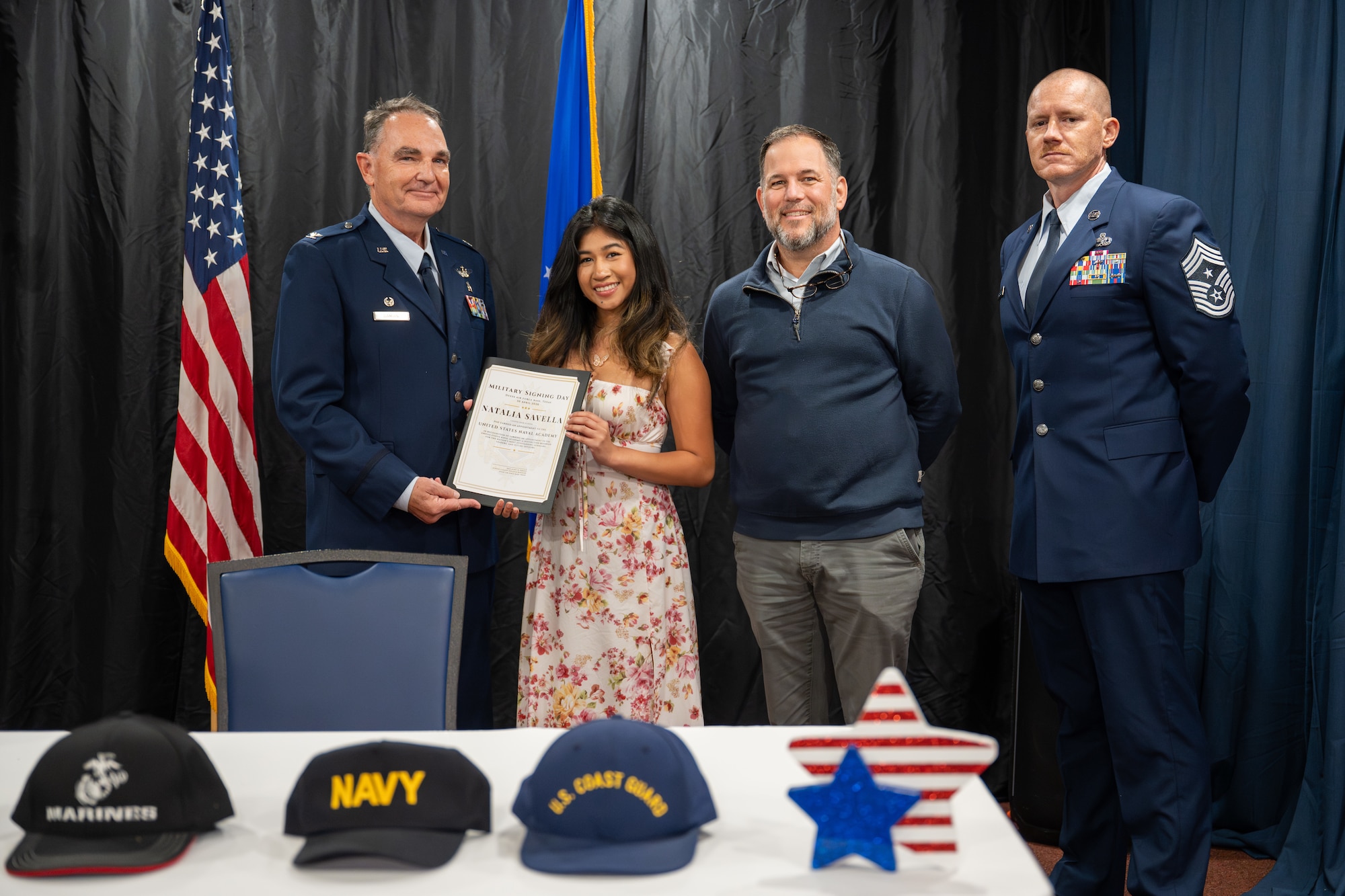 Cooper High School student Natalia Savella is congratulated by 7th Bomb Wing leadership and a CHS assistant principal on her admittance to the U.S. Naval Academy during a signing day event at Dyess Air Force Base, Texas, April 30, 2026. Many of the students honored at the event will attend basic training this summer, marking the first step in their military careers before advancing to their specialized individual training. (U.S. Air Force Photo by Airman 1st Class Caleb Schellenberg)