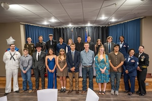 Sixteen local high school students pose alongside military recruiters for a photo during the first Military Signing Day event at Dyess Air Force Base, Texas, April 30, 2026. Many of the students honored at the event will attend basic training this summer, marking the first step in their military career before advancing to their specialized individual training. (U.S. Air Force Photo by Airman 1st Class Caleb Schellenberg)