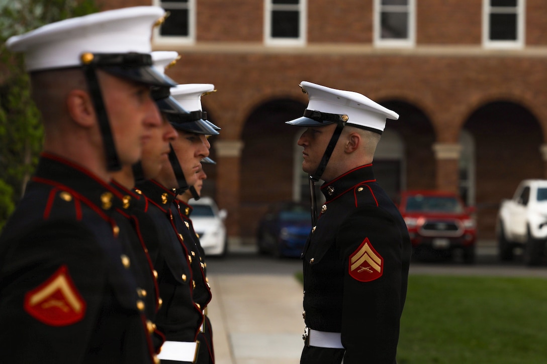 U.S. Marines with Bravo Company, Marine Barracks Washington, stand at attention during firing party tryouts for the Coca-Cola 600 at Marine Barracks Washington, D.C., on April 20, 2026. Squads from Alpha and Bravo Company competed against each other to determine which would serve as the lead firing party for the Coca-Cola 600 at Charlotte Motor Speedway in North Carolina and all other major events for the remainder of the year. The firing party performs at more than 300 ceremonial events annually, including military funerals, parades and official ceremonies. (U.S. Marine Corps photo by Pfc. Landon Heredia)