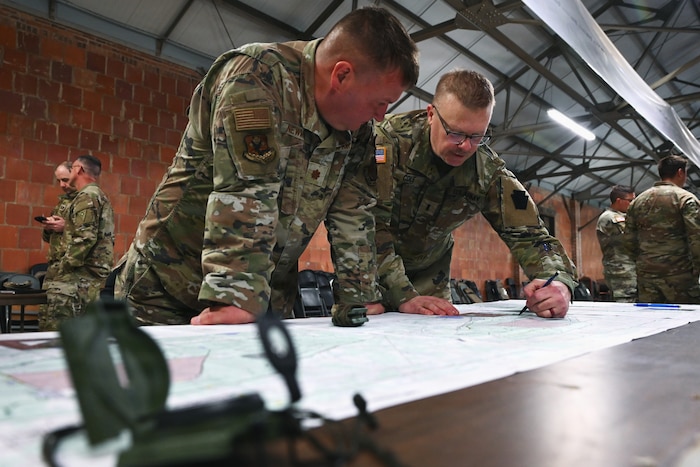 Chaplains determine an azimuth on a map during land navigation training