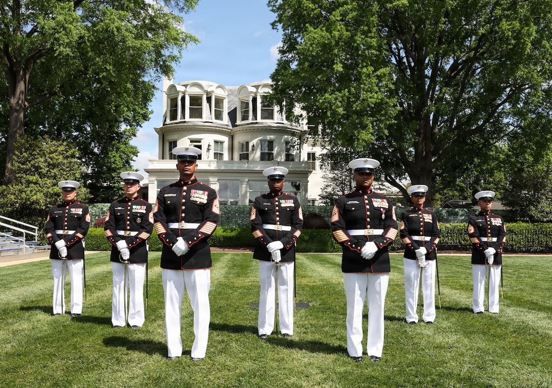 U.S. Marines on the relief and appointment staff, Marine Barracks Washington, stand behind Sgt. Maj. Jimmy F. Richard, right, outgoing sergeant major, and Sgt. Maj. Juan P. Segura, incoming sergeant major, following the relief and appointment at Marine Barracks Washington, D.C., April 17, 2026. The relief and appointment ceremony is a time-honored tradition that formally signifies the transfer of responsibility between senior enlisted leaders. Sgt. Maj. Juan Segura is appointed as sergeant major of 8th & I as the installation celebrates 225 years since its founding and the battalion prepares for America's 250th birthday. (U.S. Marine Corps photo by Cpl. Brynn L. Bouchard)