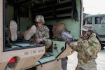 U.S. Army Soldiers of the Medical Detachment, or MEDDET, Garrison Support Command, Vermont Army National Guard, conduct a simulated casualty evacuation at Range 6-3 during Task Force Centennial Alliance 2026, Ethan Allen Firing Range, Jericho, Vt., April 22, 2026. U.S. Army Pfc. Sheila Watson, 181st Engineer Construction Company, Massachusetts Army National Guard, practices using a radio under the guidance of MEDDET’s experienced, non-commissioned officers. Photo by Sgt. 1st Class Barb Pendl.