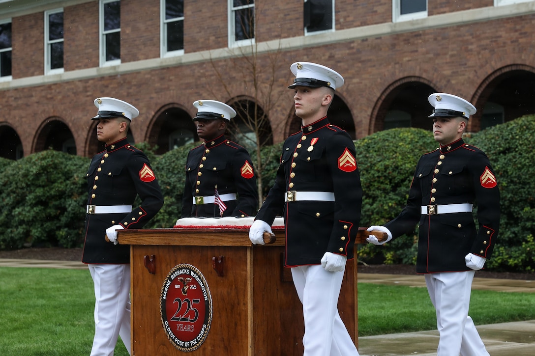 U.S. Marines with Headquarters and Service Company, march the Marine Barracks Washington 225th birthday cake during the celebration of 8th and I's birthday at Marine Barracks Washington, D.C., March 27, 2026. The symbolic passing of cake from Marine with the most time at 8th & I to the newest Marine represents the transfer of knowledge, experience, and tradition. The first piece goes to the guest of honor, and the second to the oldest Marine. (U.S. Marine Corps photo by Cpl. Brynn L. Bouchard)