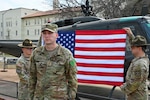 U.S. Army Spc. David Wilkinson stands in front of a U.S. flag after his promotion ceremony on March 3, 2026. Formerly an 11B Infantryman, Wilkinson received full relief from the Department of War, after being reinstated under the COVID-19 reinstatement program, including backpay, entitlements, benefits, constructive service credit, and promotion to specialist. He is now training as a 68W Combat Medic as he continues his career in the Army.