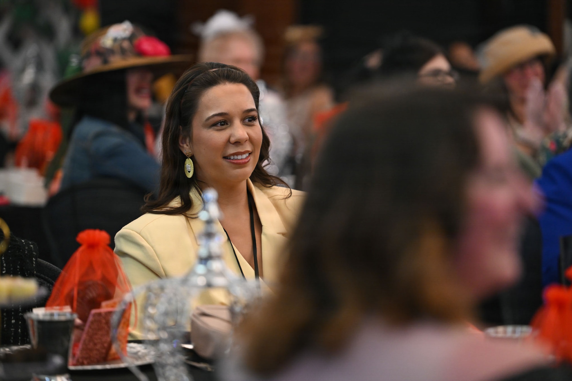 Meagan Childers, military spouse, receives information about the “Military Spouse Story Highlights” gallery during the military spouse appreciation event at Joint Base Andrews, Maryland, May 1, 2026.
