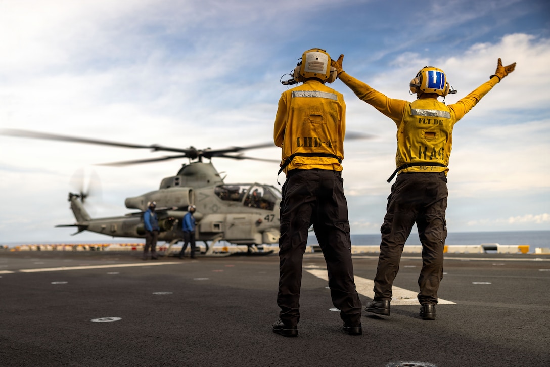 U.S. Sailors assigned to Wasp-class amphibious assault ship USS Boxer (LHD 4), render hand and arm signals to a U.S. Marine Corps AH-1Z Viper assigned to Marine Medium Tiltrotor Squadron (VMM) 163 (Reinforced), 11th Marine Expeditionary Unit, during flight operations in the Pacific Ocean, May 2, 2026.
