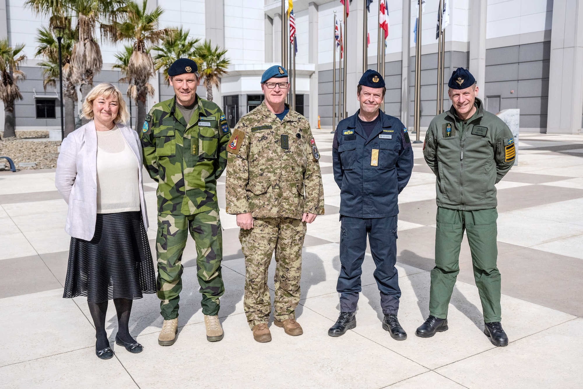 A group of soldiers and civilains pose