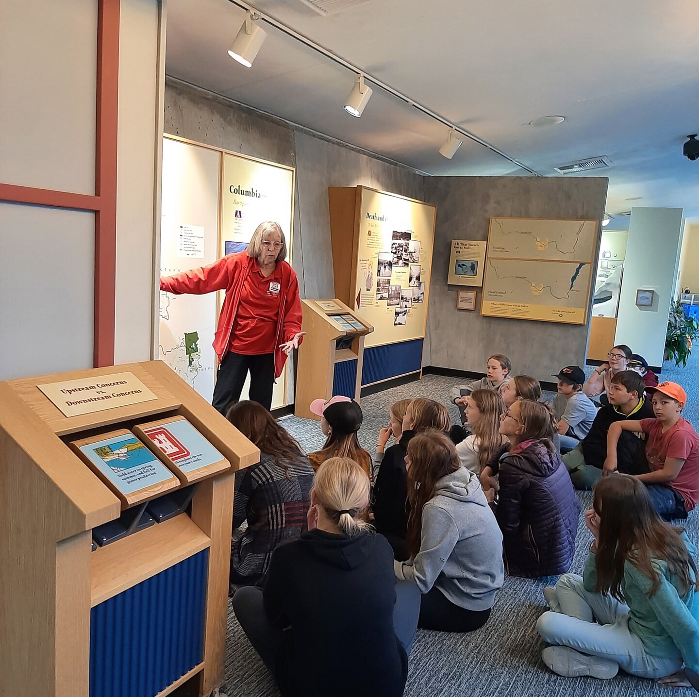 An woman is teaching a group of school-aged children, during their tour group at Libby Dam, in Libby, Montana.