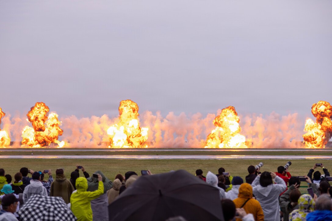 Guests observe an explosive charge detonation as part of the Marine Air Ground Task Force demonstration during Friendship Day at Marine Corps Air Station Iwakuni, May 3, 2026. The JMSDF-MCAS Iwakuni Friendship Day is hosted annually to strengthen relationships with the host community and offer a cultural exchange that highlights the mutual support between the U.S. and Japan. (U.S. Marine Corps photo by Lance Cpl. Maikeyla Reyes)