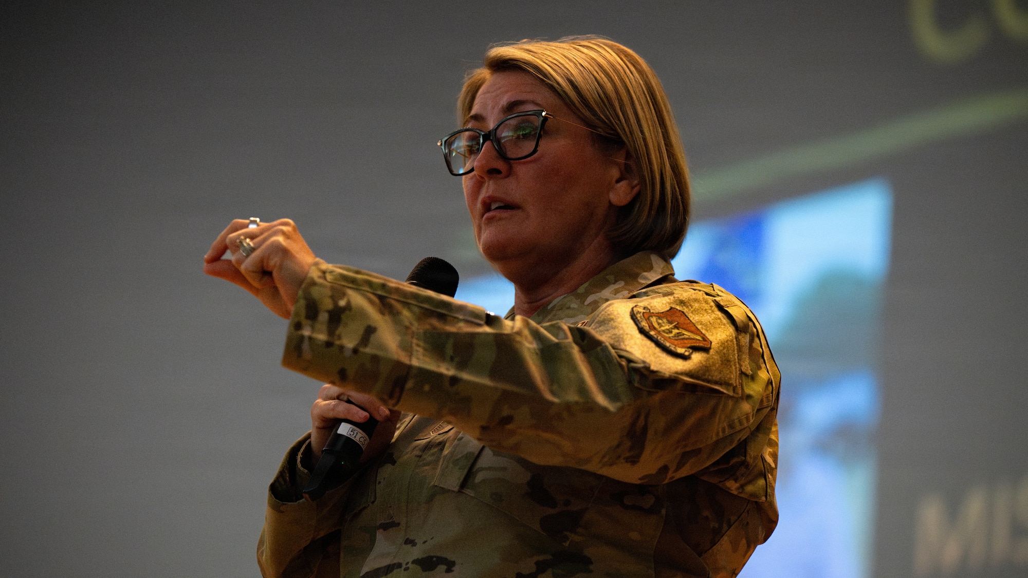 U.S. Air Force Chief Master Sgt. Katie McCool, Pacific Air Forces command chief, addresses Airmen during an enlisted all-call at Osan Air Base, Republic of Korea, April 23, 2026. McCool emphasized the importance of Airmen connecting with Air Force values, the mission, and their Wingmen. (U.S. Air Force photo by Senior Airman Jessica Mun)