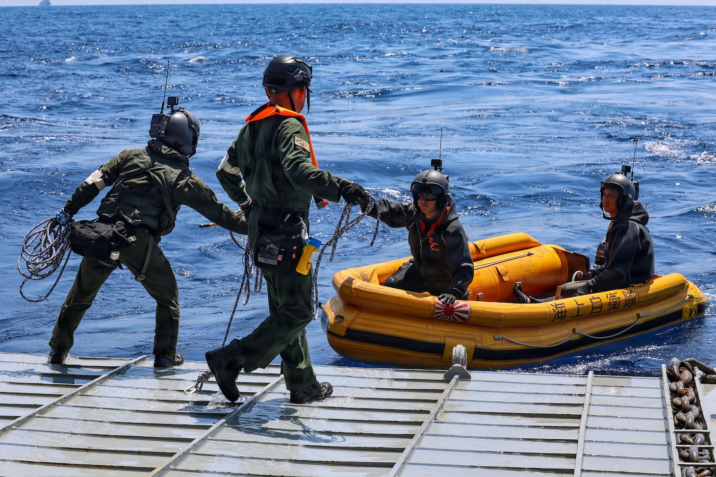 Crewmembers of a Japan Maritime Self-Defense Force ShinMaywa US-2 aircraft, assigned to Air Rescue Squadron 71 (ARS-71), Fleet Air Wing 31, secure their small boat to the stern gate of U.S. Navy Whidbey Island-class dock landing ship USS Ashland (LSD 48) during a casualty evacuation exercise for Exercise Balikatan 2026 in the South China Sea, April 27, 2026. Balikatan is a longstanding annual exercise between the Armed Forces of the Philippines and U.S. military that represents the strength of our alliance, improves our capable combined force, and demonstrates our commitment to regional peace and prosperity. (U.S. Navy photo by Mass Communication Specialist 1st Class John B. Hetherington)