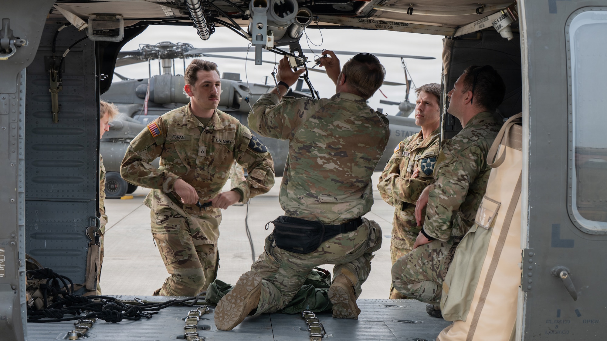 U.S. Army Soldiers assigned to the 2nd Infantry Division, 2nd Combat Aviation Brigade set up a Fast Rope Insertion Extraction System bar on a UH-60 Black Hawk in support of Tactical Air Control Party operators at Camp Humphreys, Republic of Korea, April 21, 2026. TACP operators conducted FRIES and target acquisition training during exercise Freedom Flag 26-1, simulating real-world area reconnaissance operations. FF 26-1 is a combined exercise between U.S. and Republic of Korea air forces on the Korean peninsula designed to enhance readiness through realistic, complex training scenarios. (U.S. Air Force photo by Senior Airman Jessica Mun)