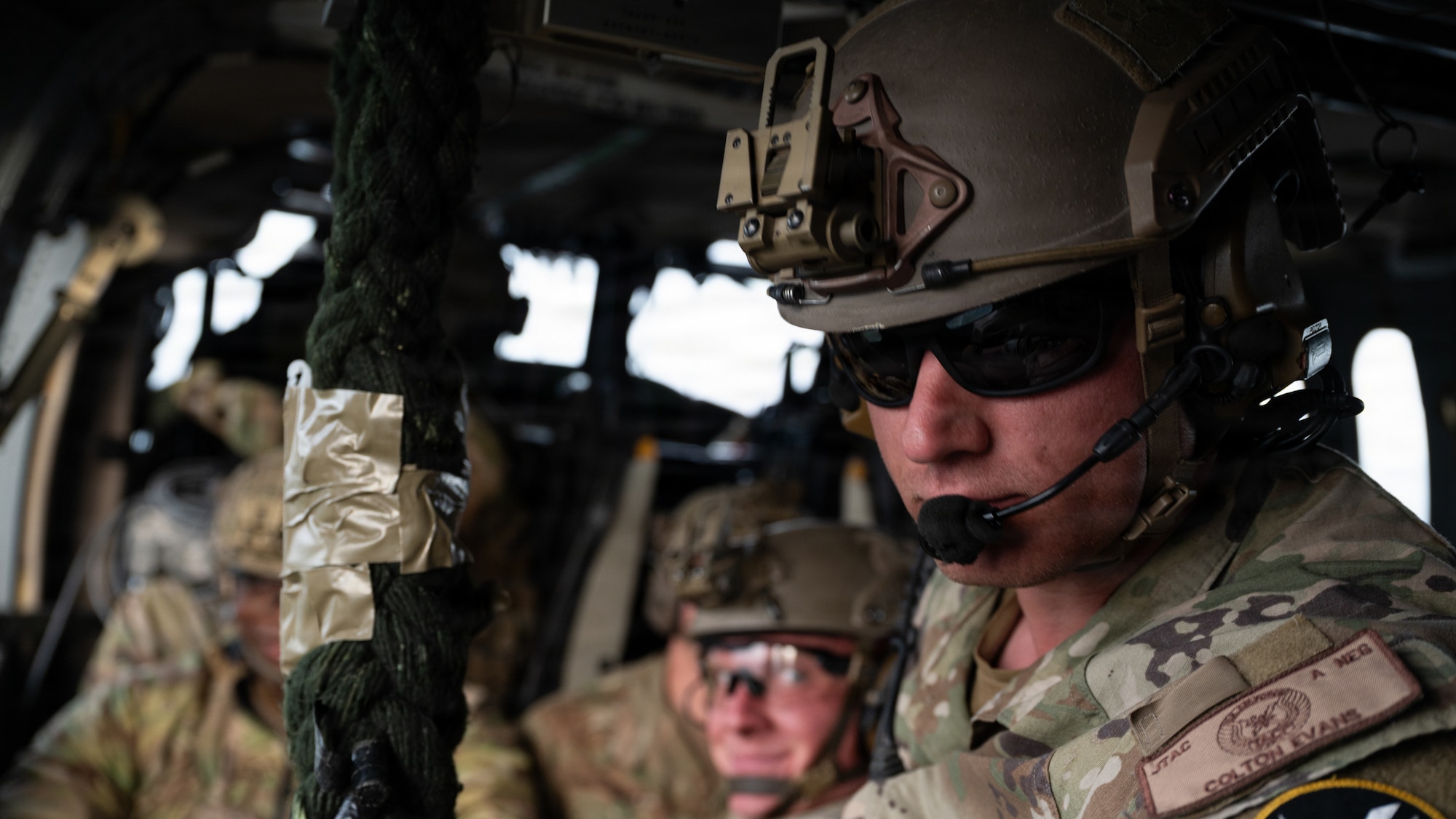 U.S. Air Force Staff Sgt. Colton Evans, Tactical Air Control Party operator and Fast Rope Insertion Extraction System master assigned to the 604th Air Support Operations Squadron, looks out of a UH-60 Black Hawk at Sobaeksan National Park, Republic of Korea, April 21, 2026. TACP operators spent a total of six days in the field, moving over mountainous terrain to track targets while using advanced communication waveforms to pass critical data to the 607th Air Operations Center during exercise Freedom Flag 26-1. FF 26-1 is a combined exercise between U.S. and Republic of Korea air forces on the Korean peninsula designed to enhance readiness through realistic, complex training scenarios.  (U.S. Air Force photo by Senior Airman Jessica Mun)