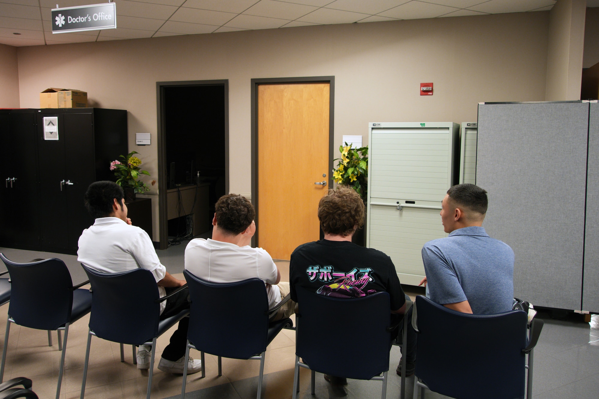 Image of four people sitting in chairs.