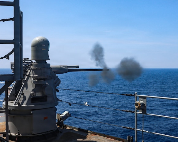U.S. Navy Whidbey Island-class dock landing ship USS Ashland (LSD 48) fires a Mark 38 25mm machine gun system at a remotely-operated target controlled by Royal Canadian Navy Halifax-class frigate HMCS Charlottetown (FFH 339) during a gunnery exercise as part of Exercise Balikatan 2026 in the South China Sea, April 25, 2026. Balikatan is a longstanding annual exercise between the Armed Forces of the Philippines and U.S. military that represents the strength of our alliance, improves our capable combined force, and demonstrates our commitment to regional peace and prosperity. (U.S. Navy photo by Mass Communication Specialist 1st Class John B. Hetherington)