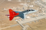 A T-7A Red Hawk soars over Edwards Air Force Base, Calif. after conducting a developmental test mission over the Mojave Desert. The Air Power Foundations Combined Test Force and T-7A Integrated Test Force continues to make progress on the aircraft, with the first aircraft arriving to Air Education and Training Command on Dec. 8, 2025, at Joint Base San Antonio-Randolph, Texas. (Air Force photo by Bryce Bennett)