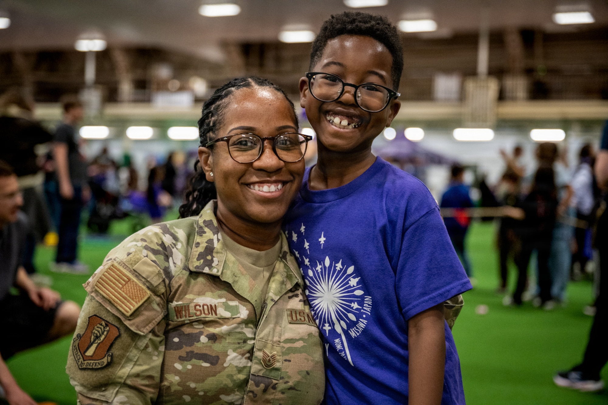 U.S. Air Force Tech. Sgt. Niketa Wilson, 35th Fighter Wing command chief executive assistant, poses for a photo with her son during Purple Palooza at Misawa Air Base, Japan, April 30, 2026.