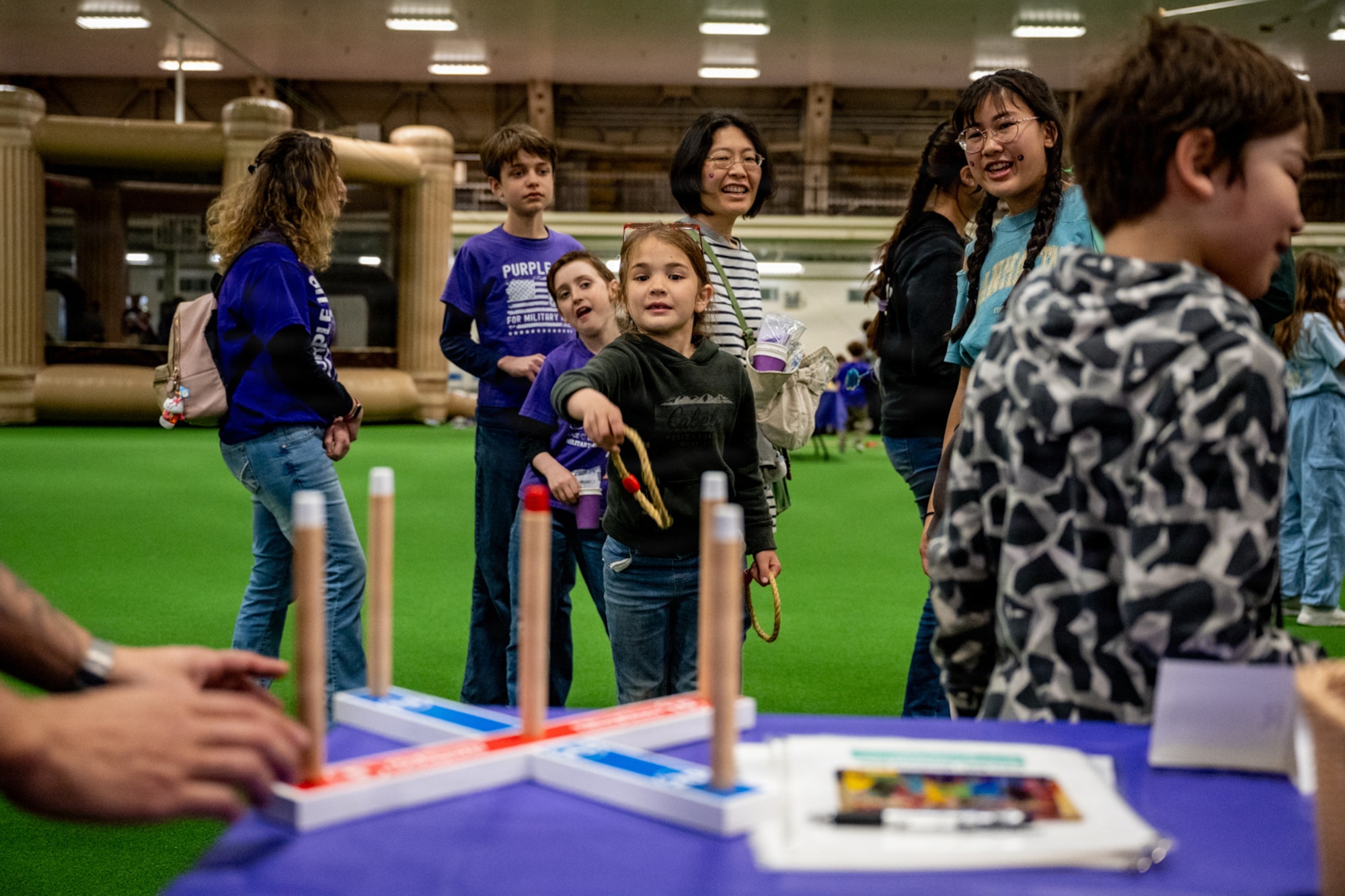 A Purple Palooza participant plays a ring toss game at Misawa Air Base, Japan, April 30, 2026.