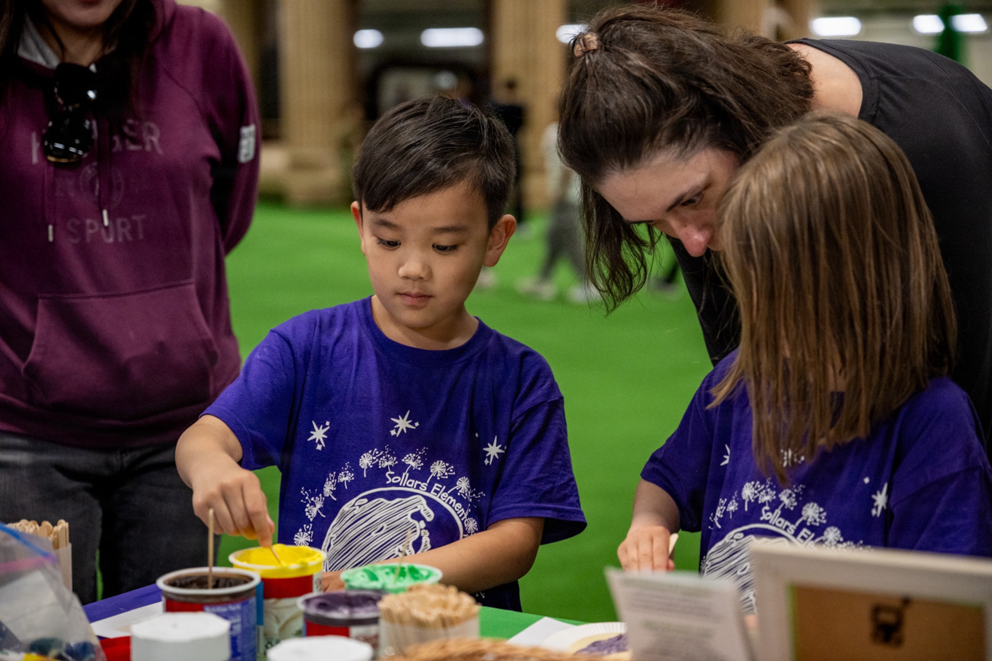 Purple Palooza participants engage in painting activities at Misawa Air Base, Japan, April 30, 2026.