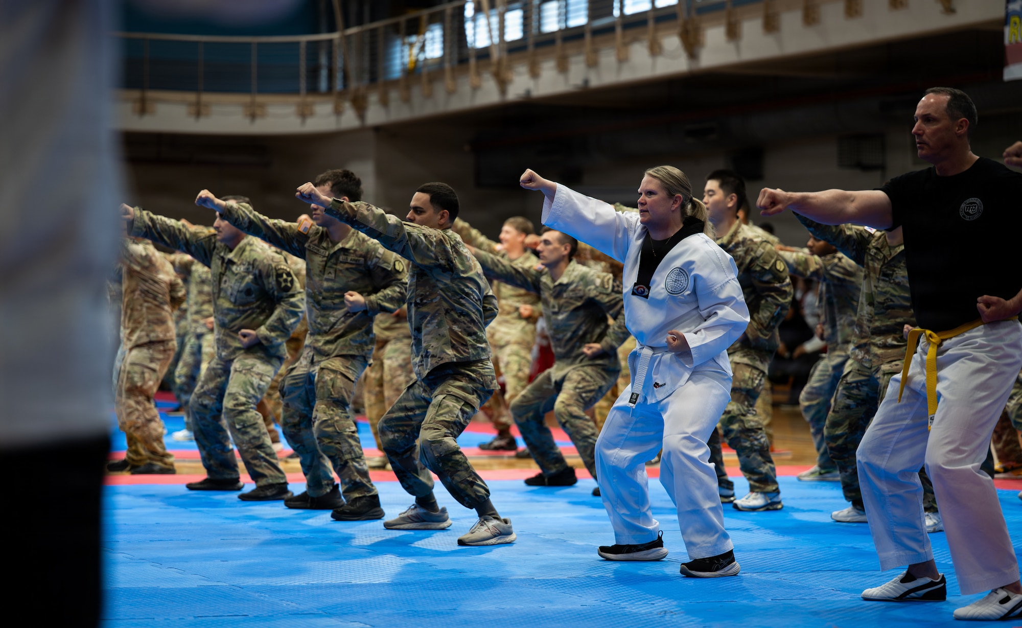 U.S. service members and spouses perform warm-up exercises during the 5th Annual Republic of Korea-U.S. Friendship Children & Family Taekwondo Exhibition Festival at Osan Air Base, ROK, May 2, 2026.