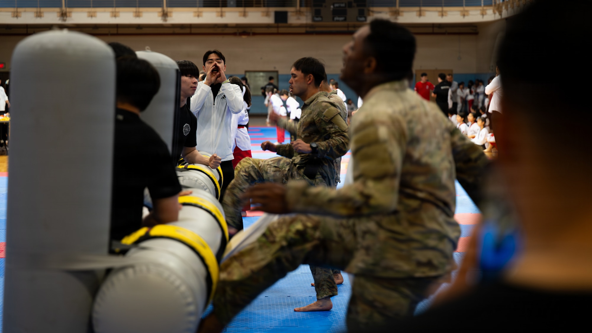 A Camp Humphreys taekwondo master cheers for U.S. soldiers during a speed kicking competition at the 5th Annual Republic of Korea-U.S. Friendship Children & Family Taekwondo Exhibition Festival at Osan Air Base, ROK, May 2, 2026.