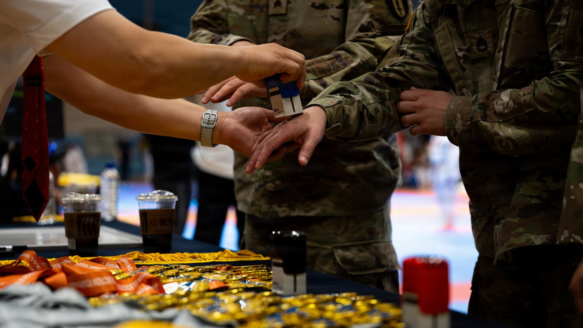 U.S. Soldiers receive hand stamps after medaling in an event during the 5th Annual Republic of Korea-U.S. Friendship Children & Family Taekwondo Exhibition Festival at Osan Air Base, ROK, May 2, 2026.