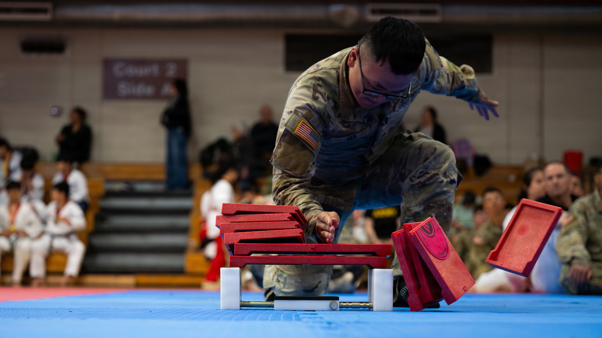 A U.S. Soldier competes in the hand blade pine board breaking event during the 5th Annual Republic of Korea-U.S. Friendship Children & Family Taekwondo Exhibition Festival at Osan Air Base, ROK, May 2, 2026.
