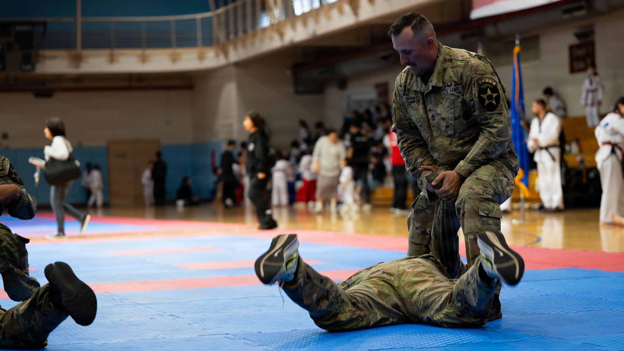 A U.S. Soldier spars with a teammate during the 5th Annual Republic of Korea-U.S. Friendship Children & Family Taekwondo Exhibition Festival at Osan Air Base, ROK, May 2, 2026.