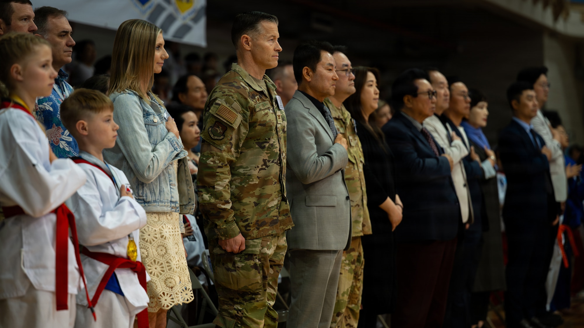 Osan Air Base senior leaders and the Foreigners Taekwondo Cultural Association stand for the playing of Republic of Korea and U.S. national anthems during the 5th Annual ROK-U.S. Friendship Children & Family Taekwondo Exhibition Festival at Osan Air Base, ROK, May 2, 2026.