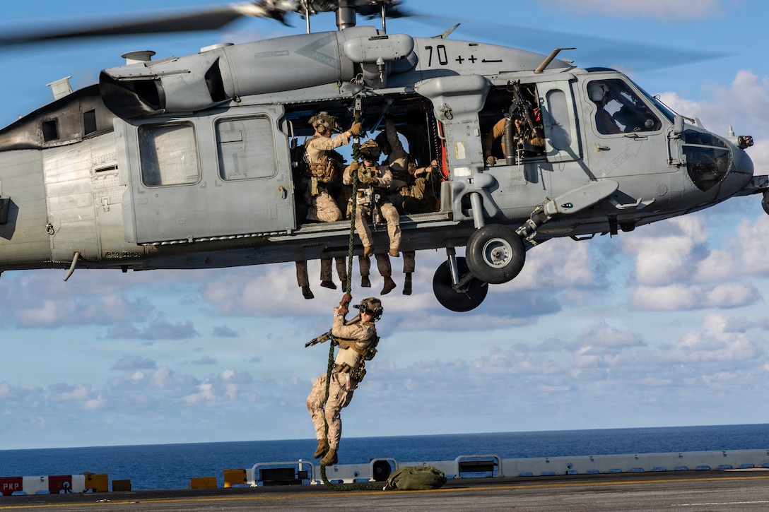 U.S. Marines with Maritime Special Purpose Force, 22nd Marine Expeditionary Unit (Special Operations Capable), fast rope from a Navy MH-60S Sea Hawk helicopter, assigned to Helicopter Sea Combat Squadron (HSC) 26, aboard Wasp-class amphibious assault ship USS Iwo Jima (LHD 7) while underway in the Caribbean Sea, April 24, 2026. U.S. military forces are deployed to the Caribbean in support of the U.S. Southern Command mission, Department of War-directed operations, and the president’s priorities to disrupt illicit drug trafficking and protect the homeland. (U.S. Marine Corps photo)
