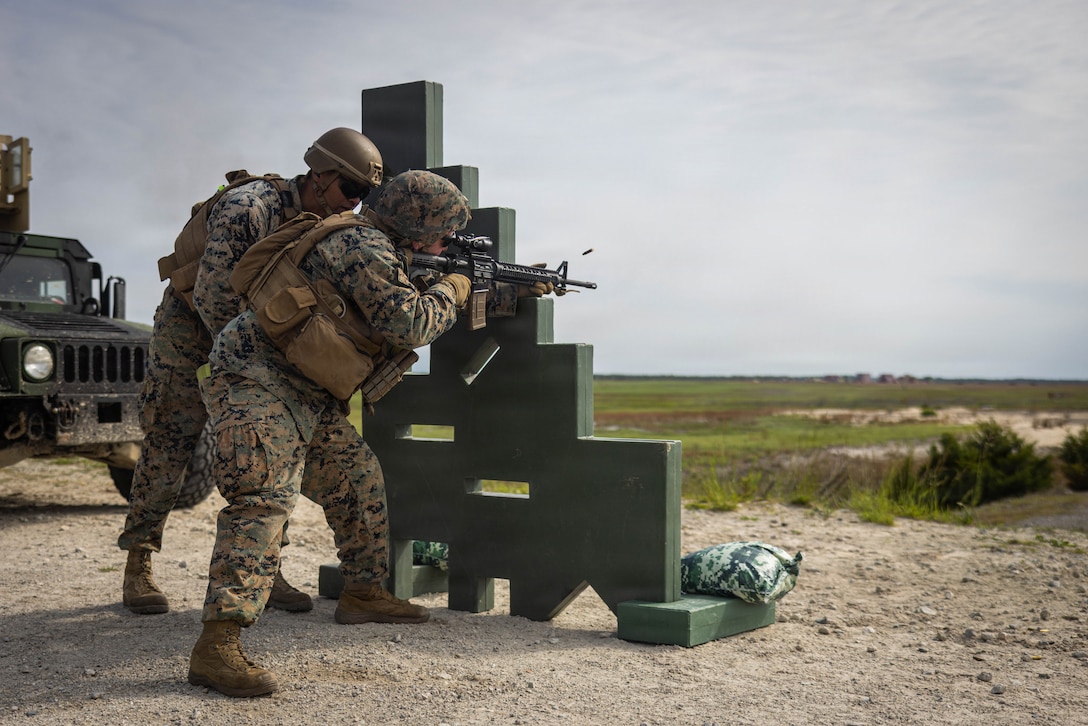U.S. Marine Corps Sgt. Tristen Kozlowski, front, a ground electronics transmission systems maintainer with Combat Logistics Battalion 2, Combat Logistics Regiment 2, 2nd Marine Logistics Group, fires an M16A4 service rifle while Capt. Greg Jones, a logistics officer with CLB-2, CLR-2, 2nd MLG, supervises during a live-fire range as part of a battalion field exercise at Marine Corps Base Camp Lejeune, North Carolina, May 1, 2026. CLB-2 conducted the Battalion FEX to complete training and readiness requirements, sustain company competencies, and enhance operational readiness in support of future mission requirements. Kozlowski is a native of California. Jones is a native of Virginia. (U.S. Marine Corps photo by Sgt. Alfonso Livrieri)