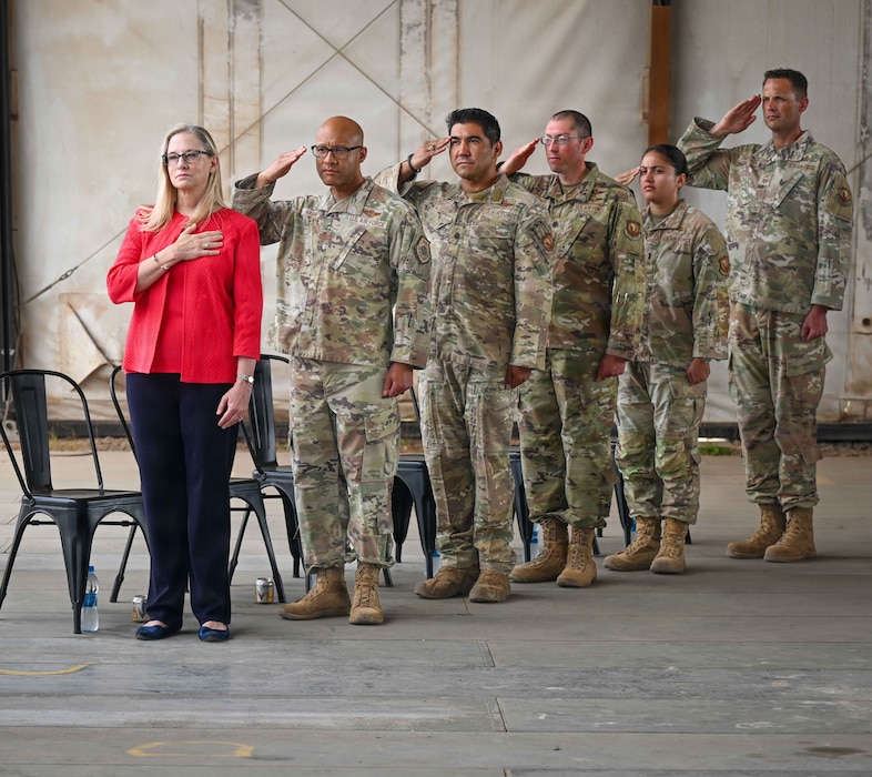 U.S. Ambassador to Djibouti Cynthia Kierscht and U.S. Airmen assigned to the 406th Air Expeditionary Wing salute the flag during the national anthem at a change of command ceremony at Chabelley Airfield, Djibouti, April 24, 2026. The change of command ceremony is a military tradition that represents a formal transfer of authority and responsibility for a unit. (U.S. Army photo by SGT Vivian Nakaana)
