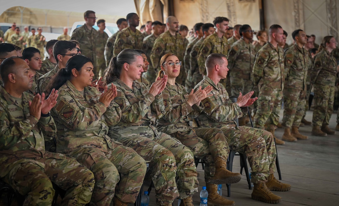 U.S. Airmen clap while attending a change of command ceremony at Chabelley Airfield, Djibouti, April 24, 2026. The change of command ceremony is a military tradition that represents a formal transfer of authority and responsibility for a unit. (U.S. Army photo by SGT Vivian Nakaana)