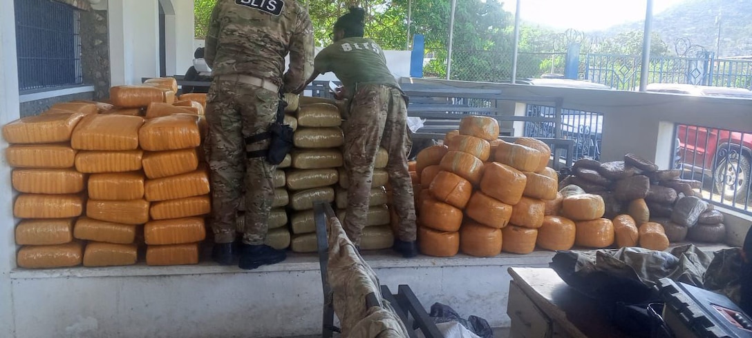 Haitian National Police members inspect interdicted drugs following a drug interdiction off Haiti, May 3, 2026. At the behest of the Haitian government, a U.S. Coast Guard law enforcement detachment deployed on the USS Billings stopped a suspected drug vessel carrying approximately 3,200 pounds of marijuana. (U.S. Coast Guard photo)