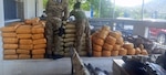 Haitian National Police members inspect interdicted drugs following a drug interdiction off Haiti, May 3, 2026. At the behest of the Haitian government, a U.S. Coast Guard law enforcement detachment deployed on the USS Billings stopped a suspected drug vessel carrying approximately 3,200 pounds of marijuana. (U.S. Coast Guard photo)
