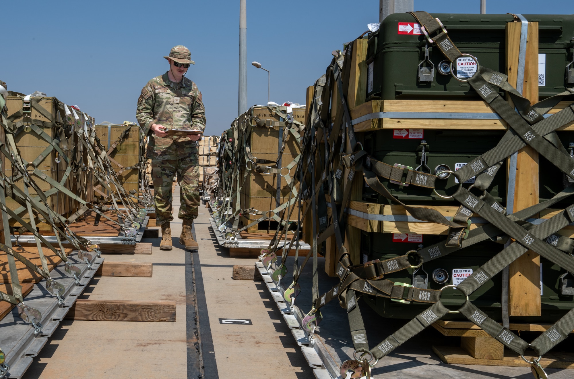 Airman looks at pallets