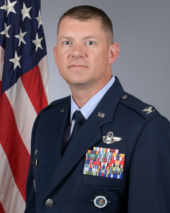 A man in a dress uniform poses for a photo.