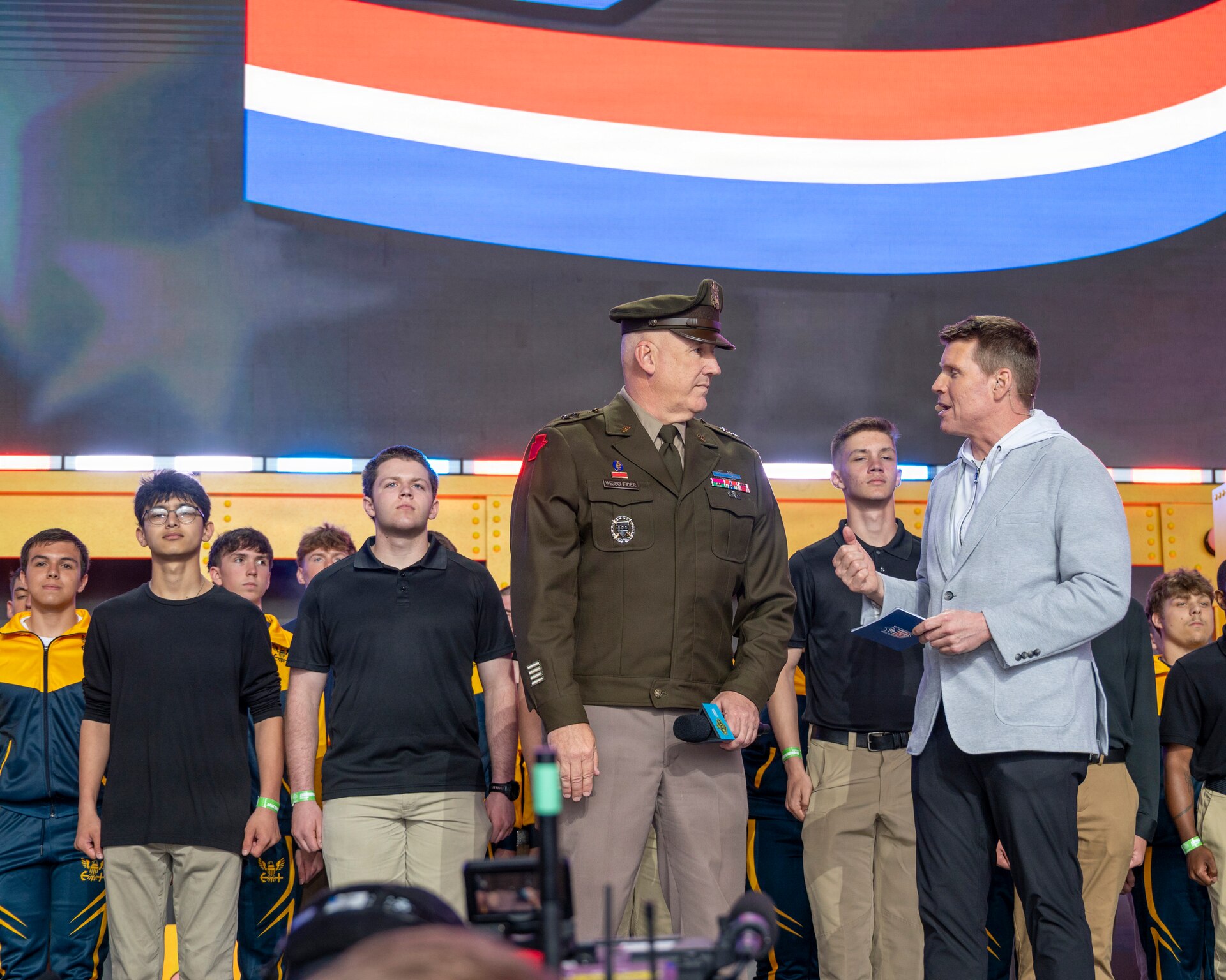 Future Soldiers and Airmen stand on stage during a multi-service enlistment ceremony at the NFL Draft at Acrisure Stadium, April 25, 2026. Approximately 180 individuals took the oath of enlistment, marking the start of their service to the commonwealth and the nation. (U.S. Air National Guard photo by Tech. Sgt. Zoe M. Wockenfuss)