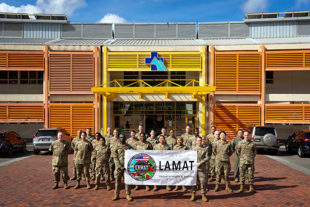 U.S. Air Force personnel pose for a photo outside the Owen King European Union hospital during the Lesser Antilles Medical Assistance Team (LAMAT) 2026 mission in Castries, Saint Lucia, April 28, 2026. The team is participating in a joint health security cooperation engagement between U.S. and Saint Lucian medical professionals working side by side to deliver care and strengthen regional medical readiness. (U.S. Air force photo by Tech. Sgt. Rachel Maxwell)