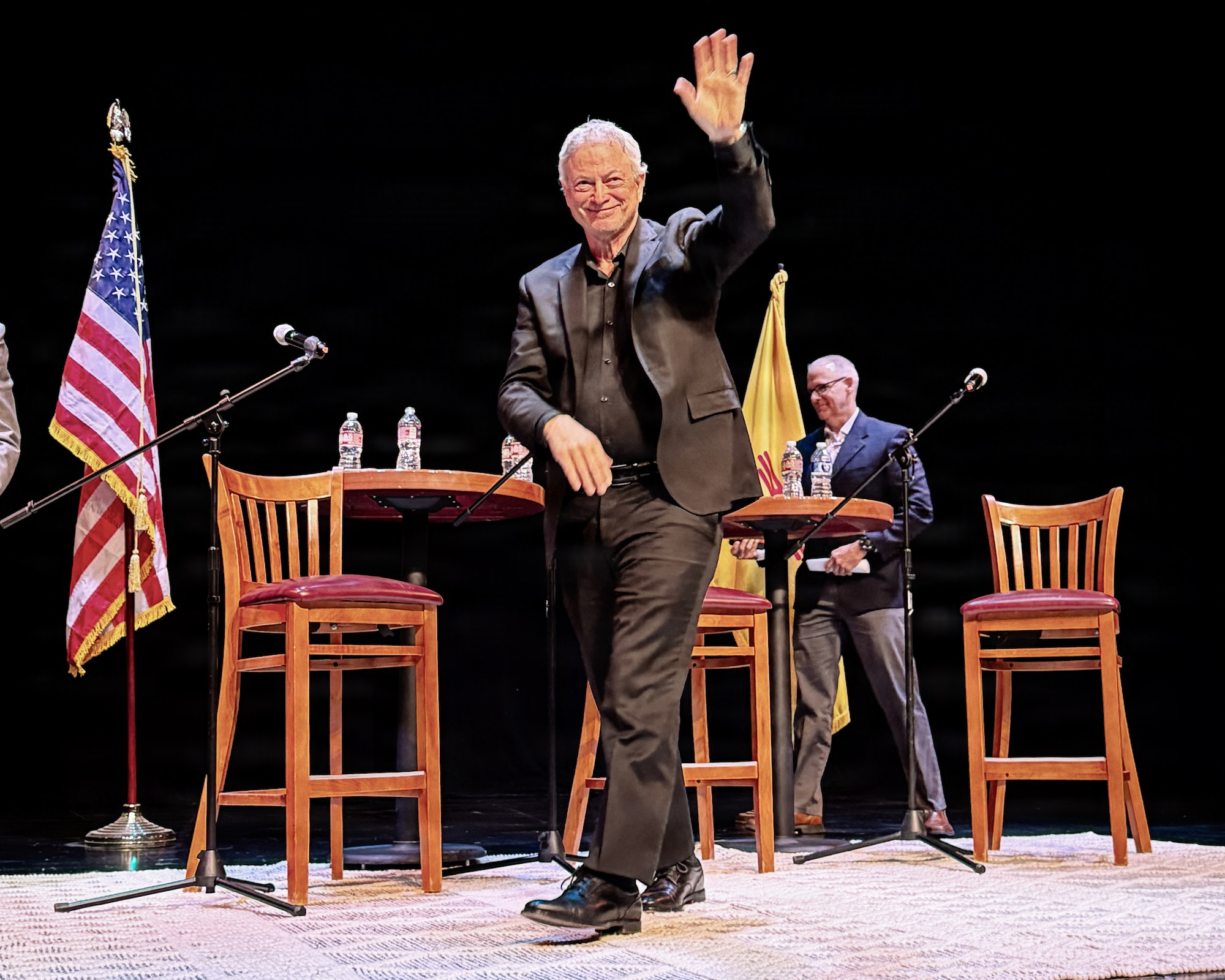Award-winning actor and humanitarian Gary Sinise waves to the audience at the Flickinger Center for Performing Arts in Alamogordo, New Mexico, Feb. 21, 2026.