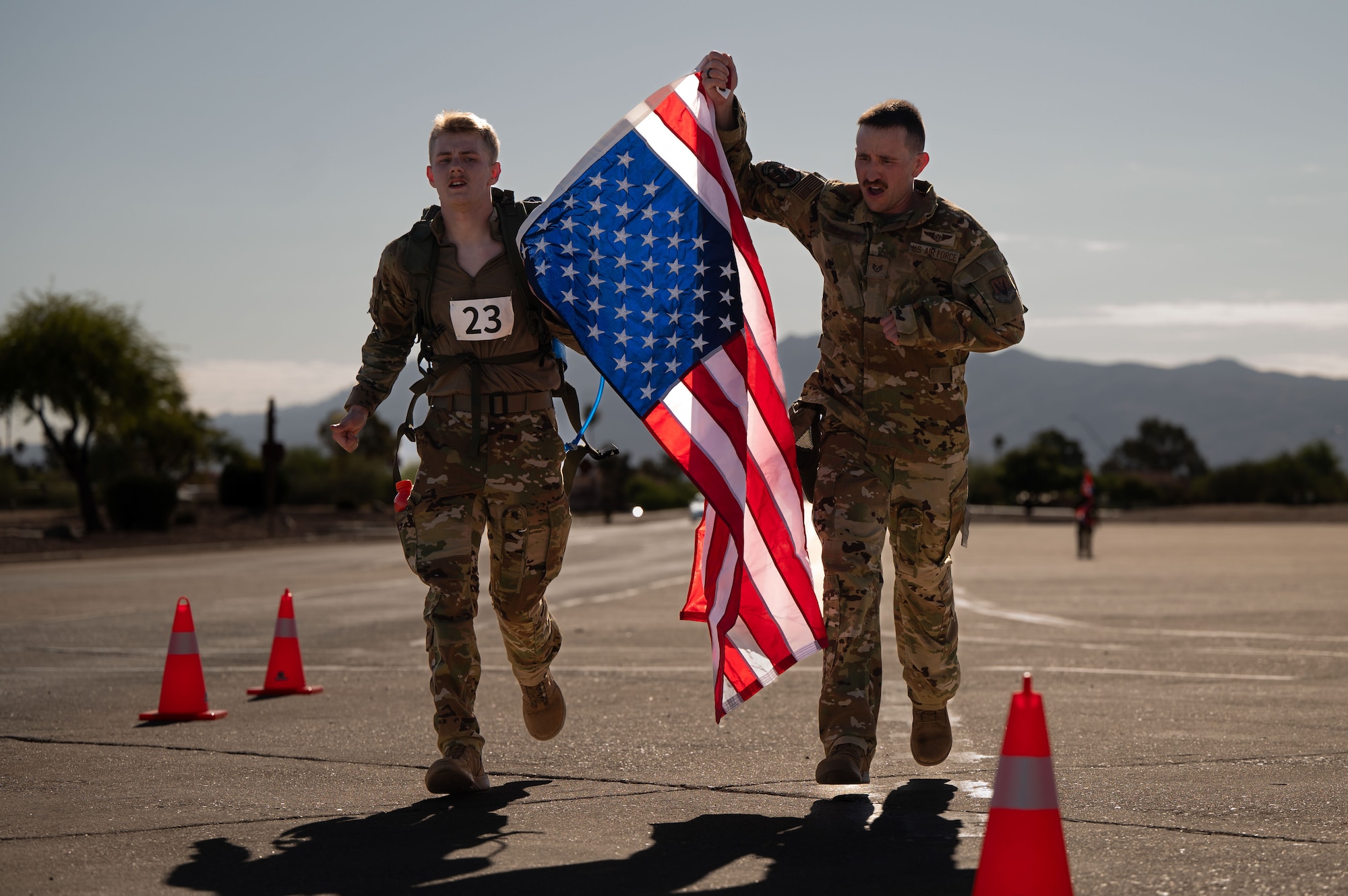 U.S. Air Force Airman 1st Class Riley Friede, left, and U.S. Air Force Staff Sgt. Nicholas McGinnis, right, both assigned to the 42nd Electronic Combat Squadron, cross the finish line of the Norwegian Foot March held at Davis-Monthan Air Force Base, Arizona, May 2, 2026. Friede crossed the finish line with minutes left in order to receive his Norwegian Foot March badge. (U.S. Air Force photo by Airman Najzee Kuzu)