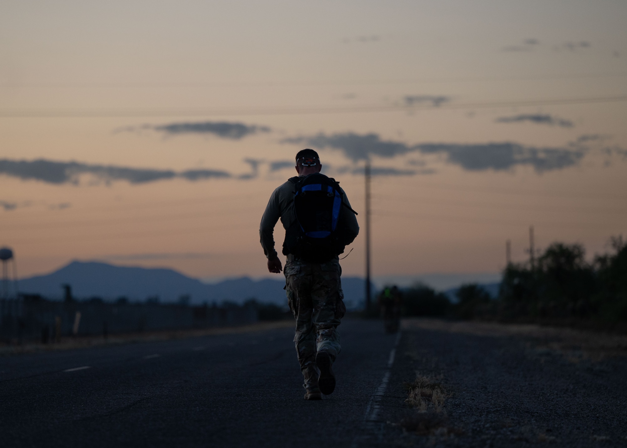 A U.S. Air Force Airman participates in the Norwegian Foot March held at Davis-Monthan Air Force Base, Arizona, May 2, 2026. Participants had to complete an 18.6-mile course wearing a combat uniform and a weighted ruck sack of 25 pounds in 4 hours and 30 minutes for men and 4 hours and 50 minutes for women. (U.S. Air Force photo by Airman Najzee Kuzu)