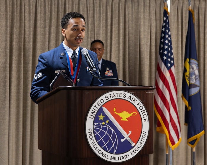 Airman speaks at podium