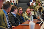Participants of the Deterrence and Escalation Game and Review (DEGRE) wargame discuss lessons learned onboard Naval Station Newport, April 17, 2026.