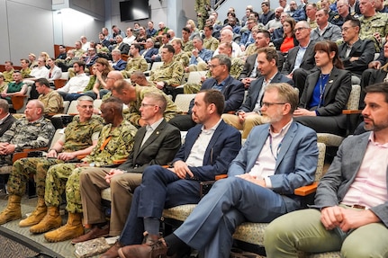 Participants of the Deterrence and Escalation Game and Review (DEGRE) wargame observe game discussions onboard Naval Station Newport, April 17, 2026.