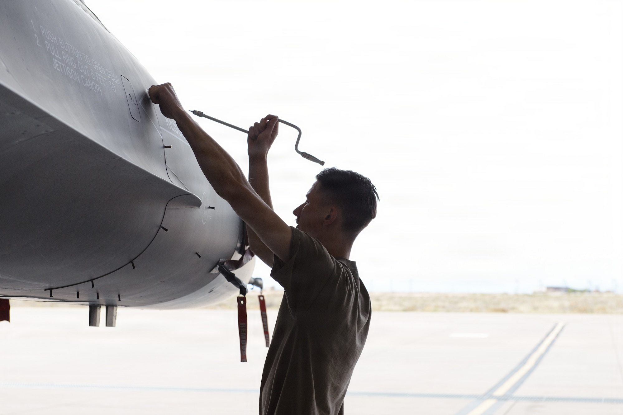 U.S. Air Force Senior Airman Bradley Cannon, 8th Aircraft Maintenance Unit avionics journeyman, opens a panel on an F-16 Fighting Falcon at Holloman Air Force Base, New Mexico, April 6, 2026.