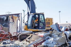 Col. Bradly Bucholz, 412th Civil Engineer Group commander, demolishes Building 1400 on Edwards Air Force Base, California, Aug. 8, 2025. The demolition of the old building paved the way for construction of the new Flight Test Engineering Laboratory. (Air Force photo by CJ Raterman)
