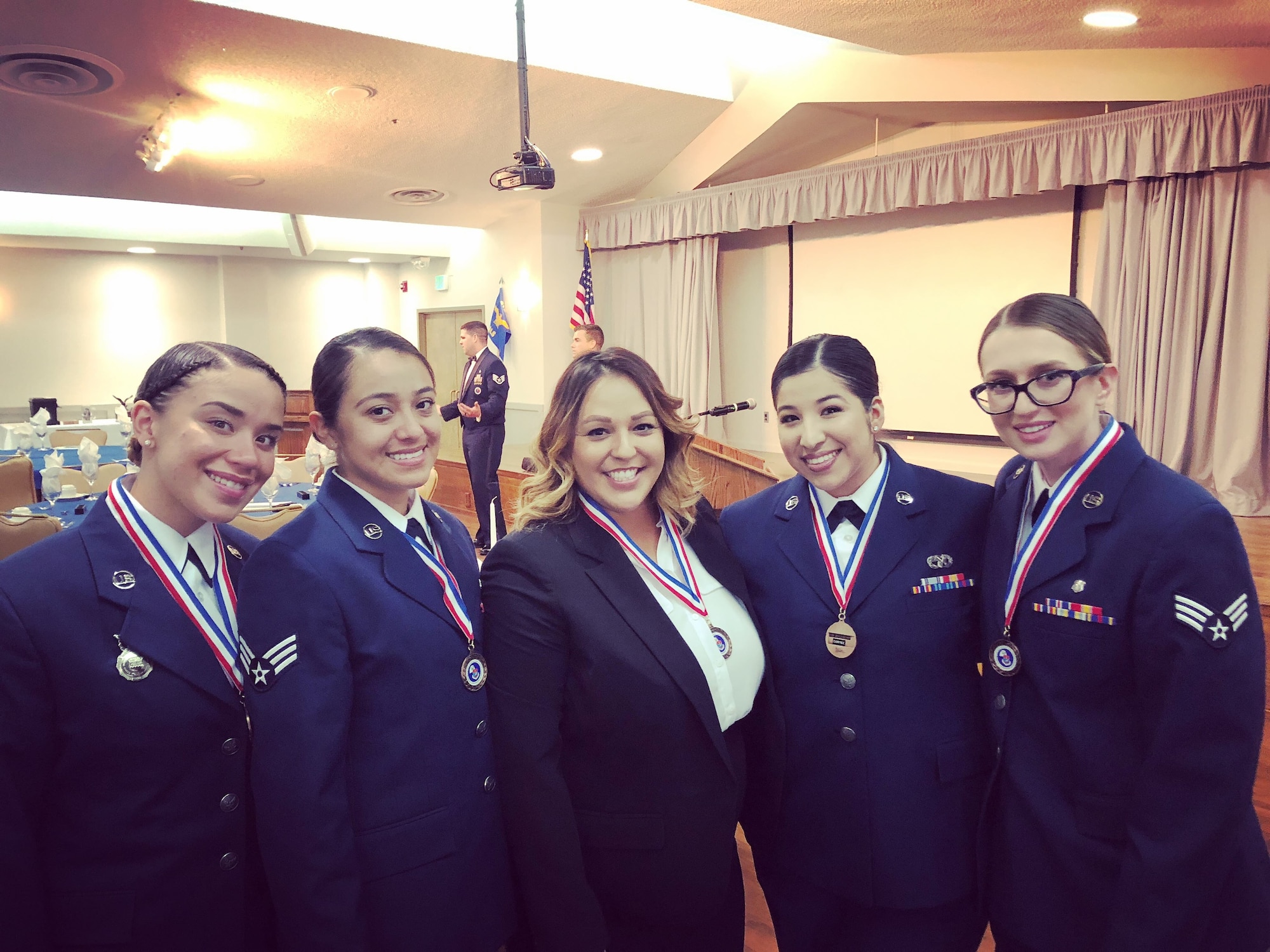 Jacqulyn Lopez, Air Force Test Center executive administrator, center, poses for a photo with Airmen after graduating from Airman Leadership School at Edwards Air Force Base, June 28, 2018. Lopez chose to immerse herself early on in her Air Force civilian career with ensuring she could become the best wingman, leader, and mentor for others. (Courtesy photo)